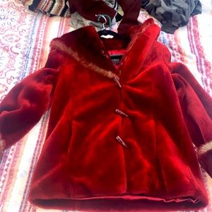 This is a fur jacket it’s a size small it’s red with buttons that go up